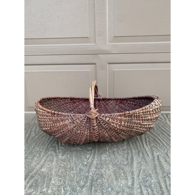 A beautifully woven early 20th century American splint oak basket with warm honeyed tones and a tightly constructed...