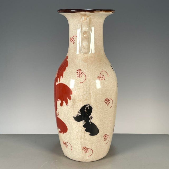 Add a touch of traditional Chinese charm to your space with this elegant double-handled porcelain vase. The vase features...