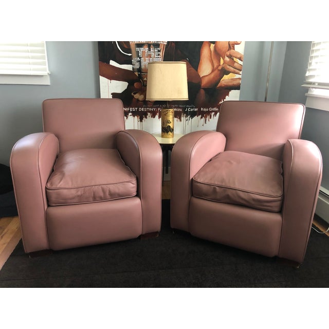Elegant pair of mauve color leather club armchairs. Custom-made in the UK, these chairs blend Modern and Art Deco styles,...