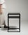 This early 21st century side table from Poland is finished in black, worked in wood. Its form follows honest, well-...