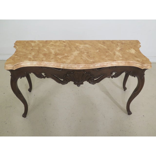 French Louis XV style faux marble top console table. Features painted faux marble top, French style and brown finish base.