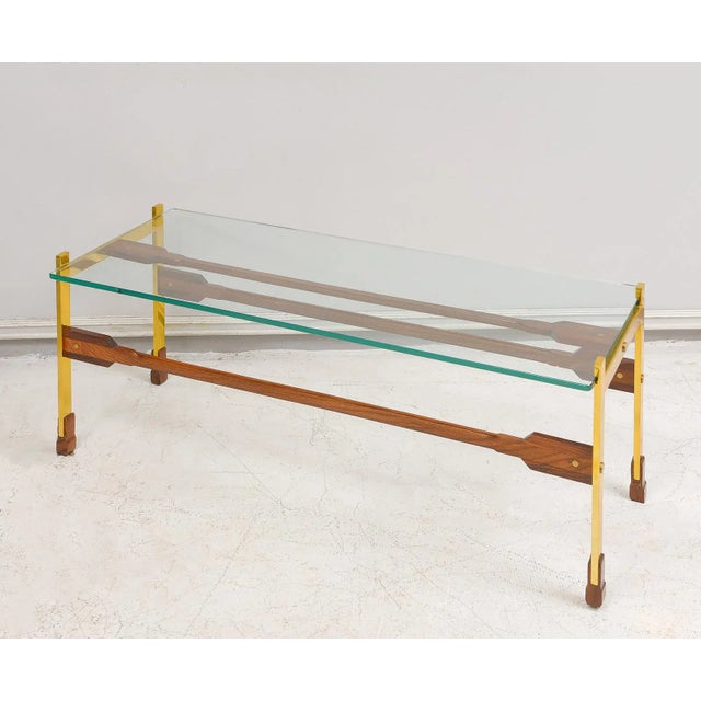 Sculptural rosewood and brass coffee table.