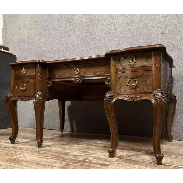 A louis xv style provençal curved desk in carved walnut, circa 1880. The projecting front opens with five drawers in three...