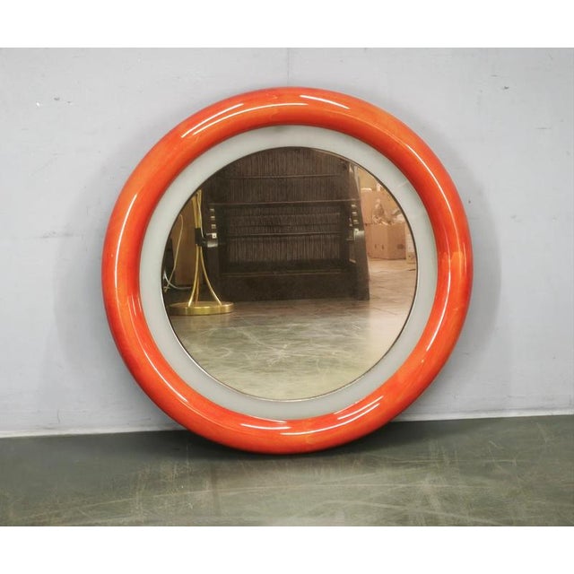 Striking Italian illuminated round wall mirror dating from the 1970s, designed with the bold sculptural character...