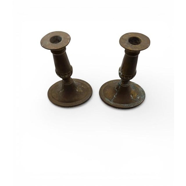 A classic pair of&nbsp;English brass candlesticks with an elegant baluster silhouette and wide, stable bases—exactly the...