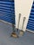 This vintage wrought iron fireplace tool set includes a sculptural scroll‑base stand, shovel, poker, and natural‑fiber...