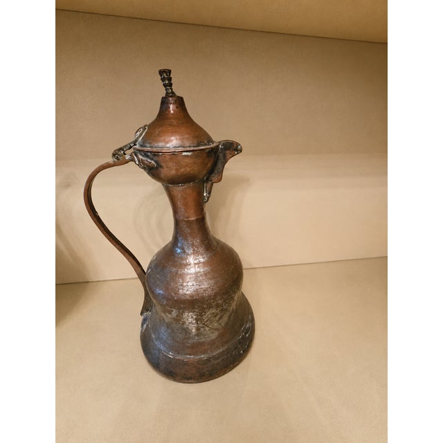 Graceful and sculptural, this antique Turkish hand-hammered copper ewer is a beautiful example of traditional Ottoman...
