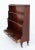 Regency Revival mahogany waterfall open bookcase Circa 1900 This bookcase stands upon turned feet with brass castors...