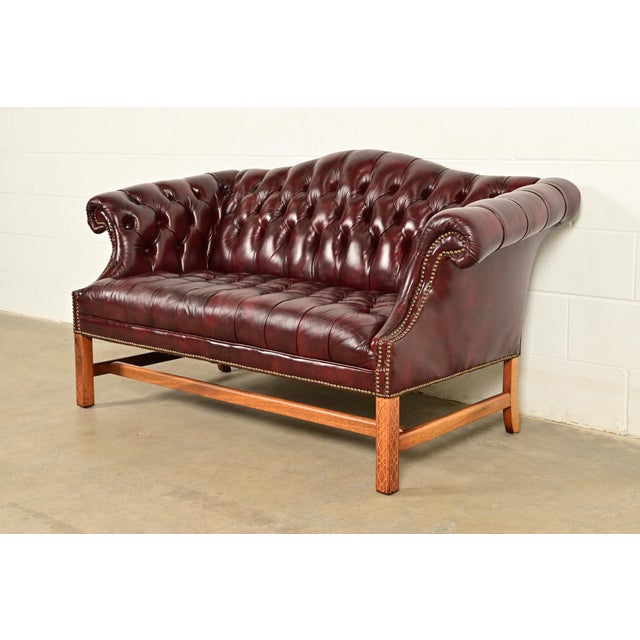 A gorgeous vintage camelback Chesterfield sofa or loveseat In the manner of Hancock and Moore By Classic Leather, Inc....