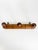 Rustic French wall-mounted coat rack dating from the 1930s, crafted from solid wood with a warm brown patina. Featuring...