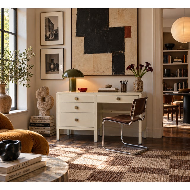 This desk brings clean, architectural lines to industrial design — a streamlined steel case finished in warm ivory, with...