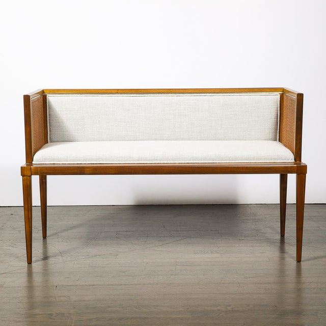 A refined Mid-Century Modernist settee that masterfully balances warm natural materials with tailored luxury. Crafted in...