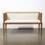 A refined Mid-Century Modernist settee that masterfully balances warm natural materials with tailored luxury. Crafted in...
