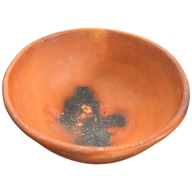 A beautifully simple handmade terracotta bowl with a wonderfully organic, timeworn presence. Hand-thrown and signed by the...