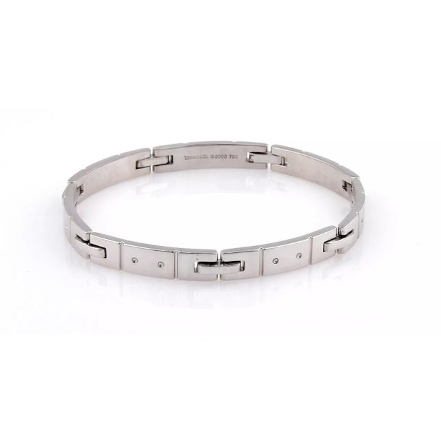 This authentic Tiffany & Co. piece is finely crafted from solid 18k white gold. It features a unique rectangular link...