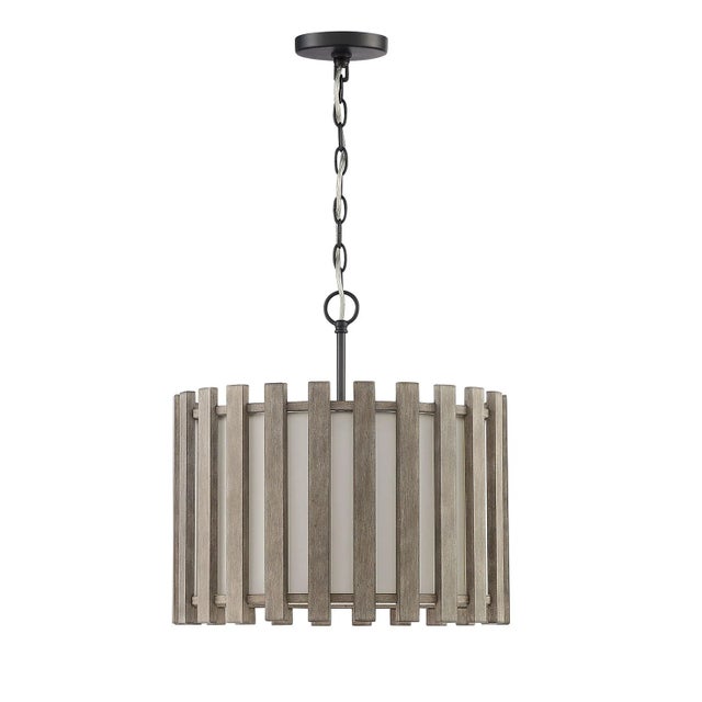 Slats of gray-washed, hand-rubbed wooden slats surround the lightly textured bronze fittings of the Inland Drum Pendant....