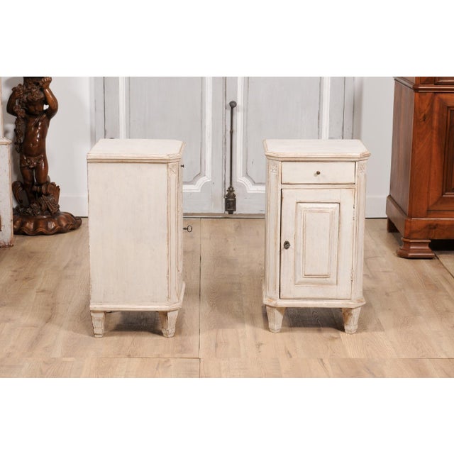 A pair of Swedish Gustavian style bedside tables from circa 1880 with light gray finish, single drawer over single door,...