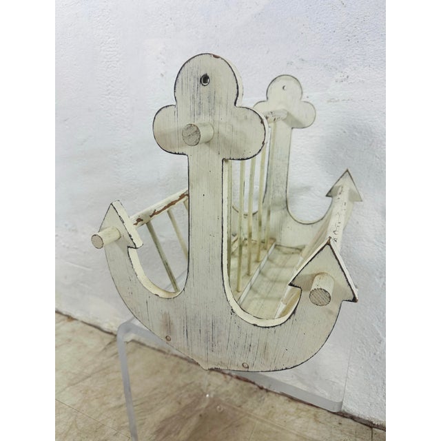 This charming vintage wooden magazine rack brings a touch of coastal cottage style with its whimsical anchor-shaped end...