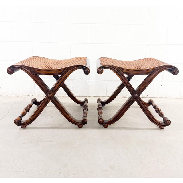 A stunning pair of campaign-style stools with elegant X-base frames and handwoven cane seats, inspired by the iconic work...
