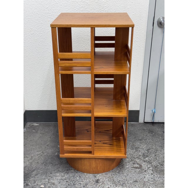 Design Plus Gallery presents a Rotating Bookcase in Teak Wood. The timeless style wood bookcase sits on a revolving base...