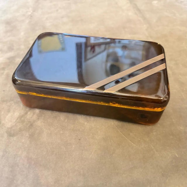 Capturing the opulent essence of 1970s high-society design, this exquisite decorative box is a masterclass in Mid-Century...