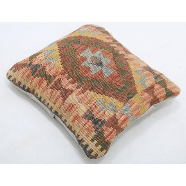 A one-of-a-kind handwoven Afghan wool kilim accent pillow featuring stepped diamond medallion. Cut and sewn by hand from a...