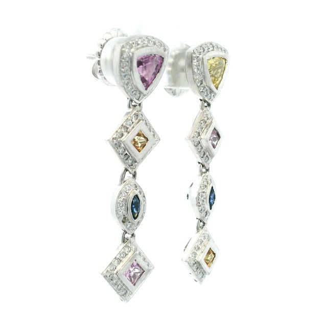 Crafted in 18-karat white gold, these contemporary Italian drop earrings feature approximately 5.00 carats of multicolor...