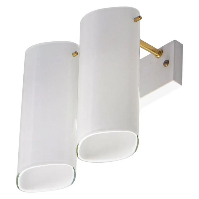 Rare model. 10 available, listed price is for a single wall lamp. 2-armed, opaline glass and brass. Produced by...