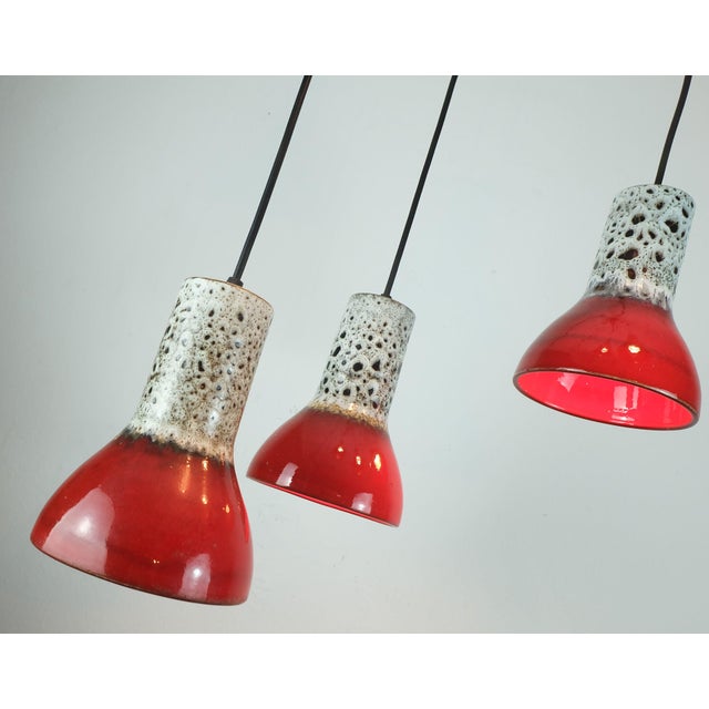 Very beautiful 1970s mid century 5-light pendant lamp. The shades are made of ceramic with fat lava glaze in white and...