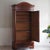 A single-door wardrobe with a mirrored door and a base drawer, stylistically attributable to the Louis-Philippe period...