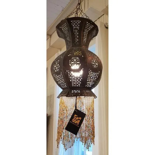 Vintage Pierced Brass Mid-Eastern, Turkey, Oriental Lamp with amber and mixed color beaded fringes. These lamps give a...
