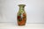 Our vase is has a detailed hand-painted Floral motif with a Taby Kitty over a tan-toned surface. The curved form is both...
