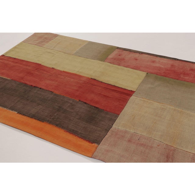 Handwoven in cotton and wool, this 5x7 vintage Turkish patchwork rug, circa 1950-1960, is a striking example of mid-...
