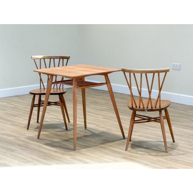 A charming and unusual mid-century Ercol dining set, designed by Lucian Ercolani in the 1960s and beautifully handcrafted...