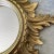 Lovely Mid Century sunburst mirror with a surround of scrolling 'rays'. This Italian mirror has a giltwood patine and is...
