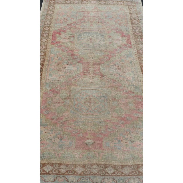 Measures: 4'5 x 8'0 Vintage Turkish Double Medallion Oushak in Neutral Earth Tones With Soft Pink. Country of Origin:...