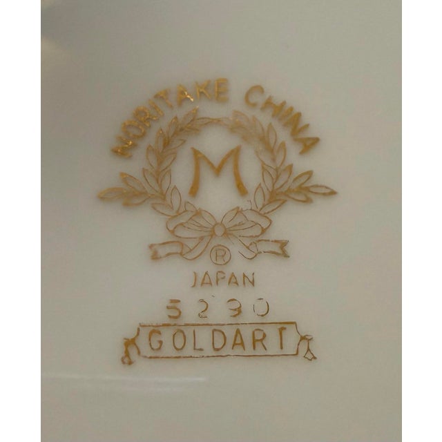 This is a collection of elegant China dinnerware predominately white featuring distinct gold rims. The Noritake China...