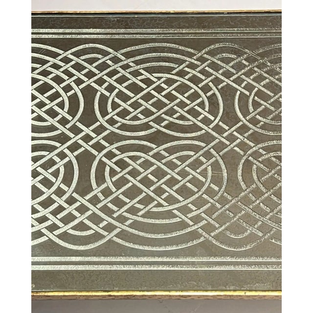 Mid-century modern rectangular shaped coffee or cocktail table with gilt finish and glass top with reverse engraved...