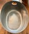 This oval-shaped, dark-colored beverage tub featuring a distinctive hammered texture was designed for chilling and serving...