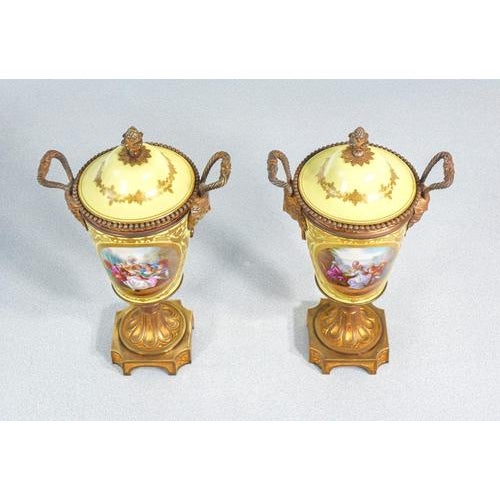 Pair of sèvres porcelain vases with lids, hand-painted with romantic scenes and signed “morin,” with gilded bronze mounts....