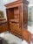 A large entertainment 4-door armoire of cherry wood by Chaddock Furniture. This is a one-piece unit. It features two key-...