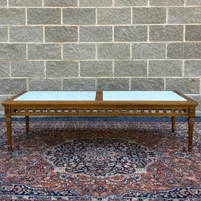A vintage Gordon's Fine Furniture French Louis XVI walnut coffee table having Italian marble inserts over a carved gold...