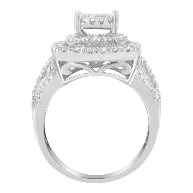 This diamond cocktail ring sparkles with a central square cluster of round diamonds surrounded by a double halo. The wide...