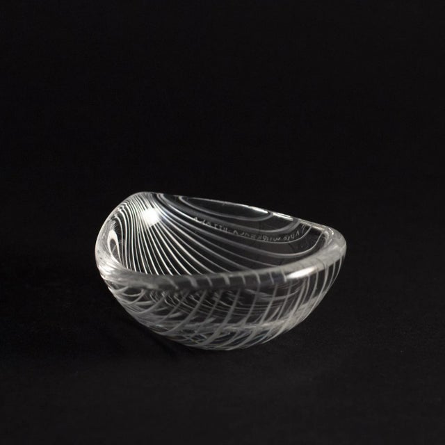 Exquisite, oval little “Kantarelli” bowl by Tapio Wirkkala. The glass is cut in a striped pattern on the outside, vividly...