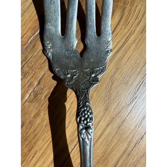 This antique piece is an 1881 Rogers silverplate cold meat serving fork designed in the highly collectible Art Nouveau "La...