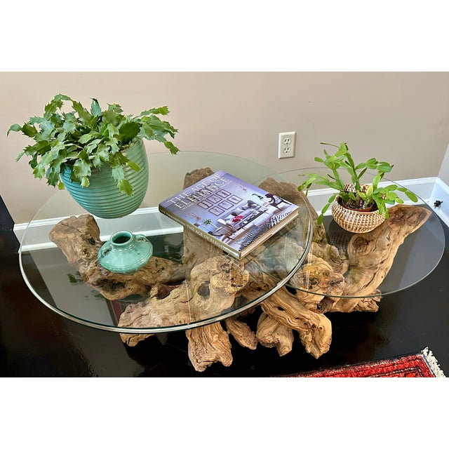 An exceptional sculptural coffee table formed from naturally aged grapevine trunks, featuring a rare double-tier glass...