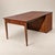 A clever 1960s Saginaw Furniture Extendomatic dining table that converts from a compact walnut cabinet into a full-size...