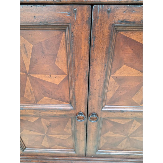 Great looking cabinet with beautiful marquetry design and warm rich looking patina. This has two drawers above two doors....