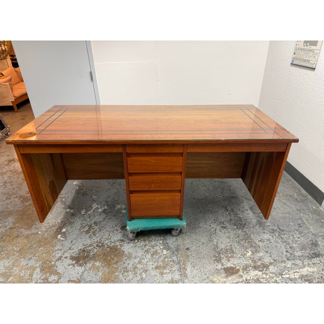 Design Plus Gallery presents a Mid-Century Modern Style Walnut Executive Desk. The desk has a broad rectangular walnut...