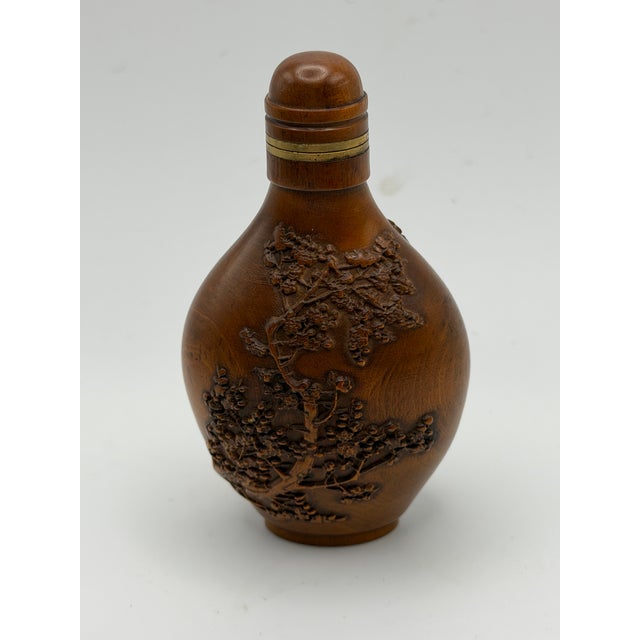 This is a fine example of contemporary snuff bottles. It is carved out of box wood and decorated with raised detailed...